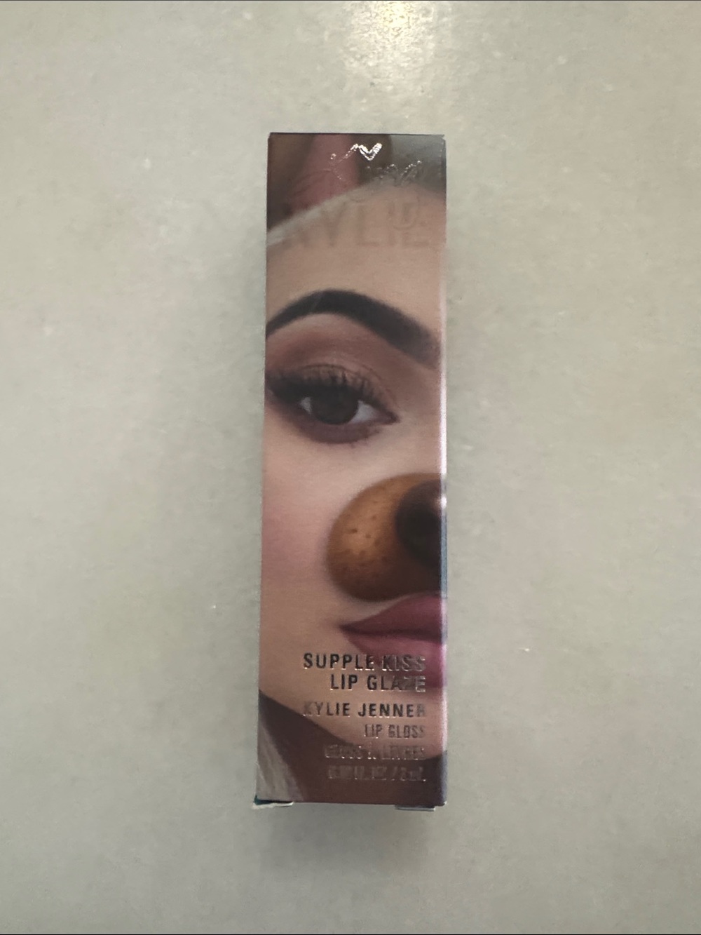 Kylie Cosmetics Supple-Kiss Lip Glaze - sheer peachy shade with gold shimmer